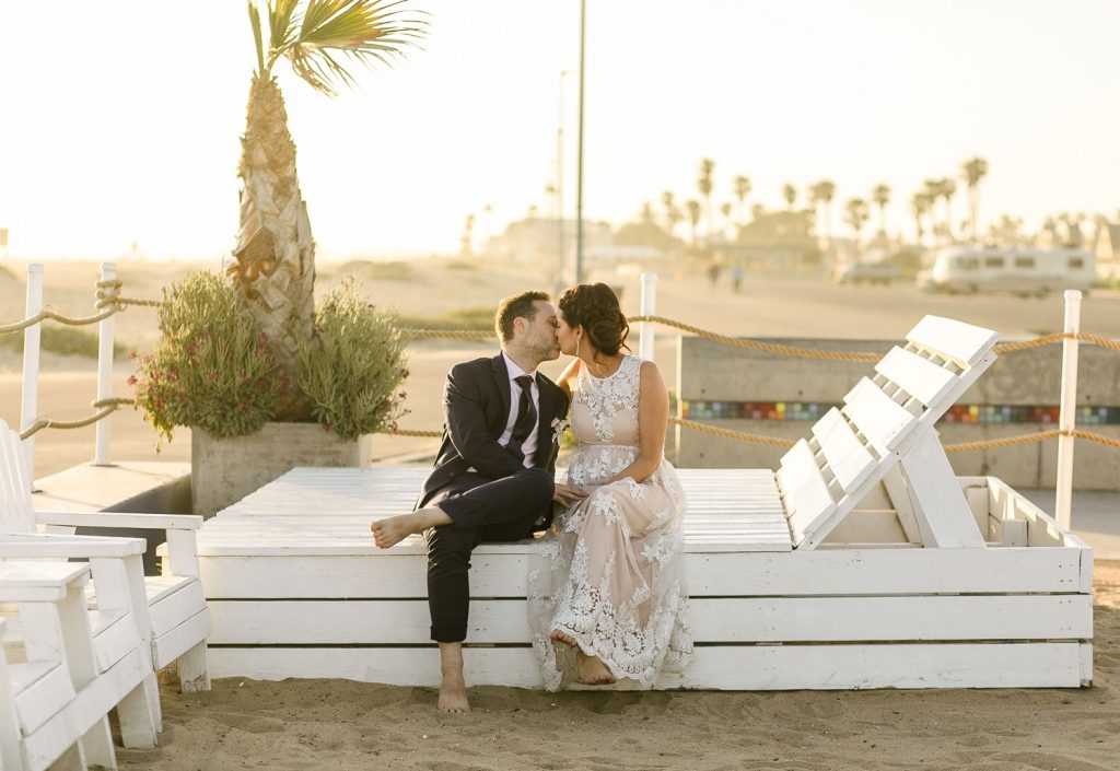 Bride and groom kissing in HB