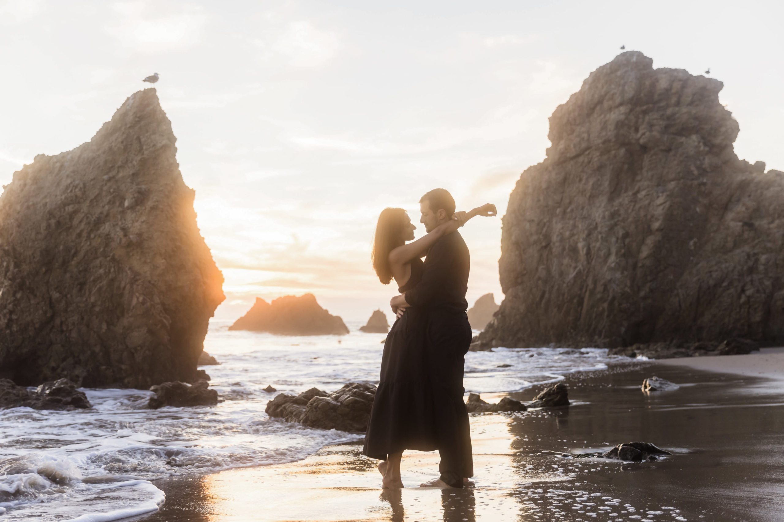 Couple sharing an embrace with sun shining behind them, taken by Temecula wedding photographer Christopher Brown