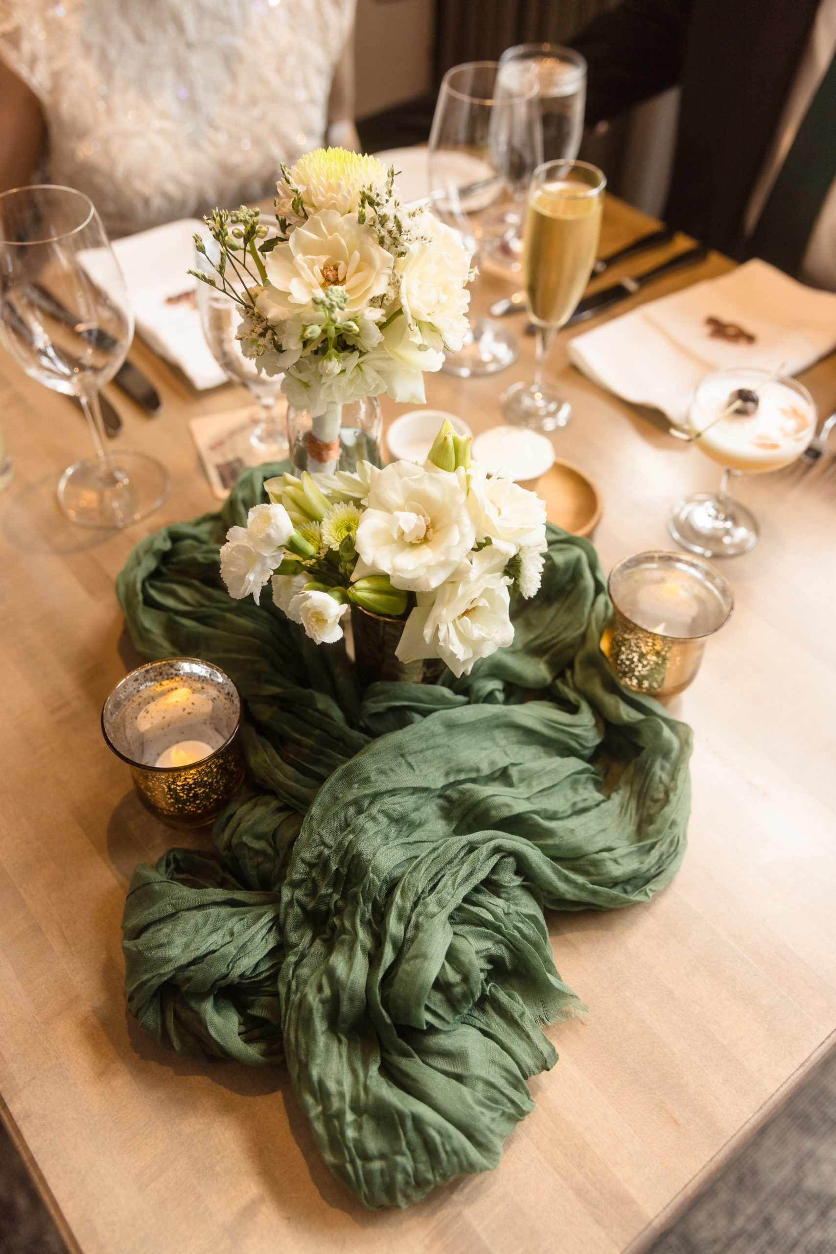 The Ultimate Wedding Guide For Five Crowns In Corona Del Mar. Close-up shot of wedding reception table with floral centerpiece.