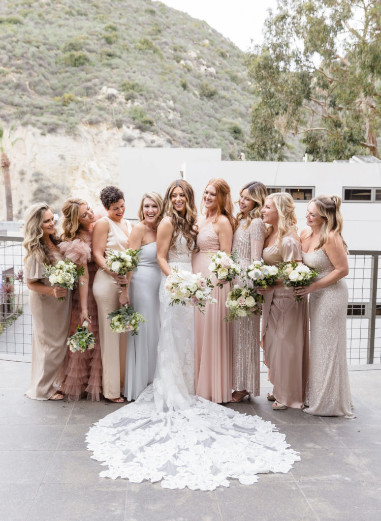 Bride posing candidly with her bridesmaids during their wedding shoot, taken by Orange County wedding photographer Christopher Brown