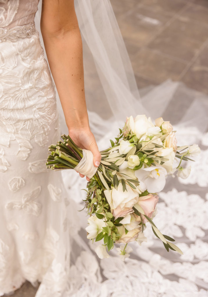 Close-up shot of bride holding her bouquet by her side, captured by Christopher Brown Weddings