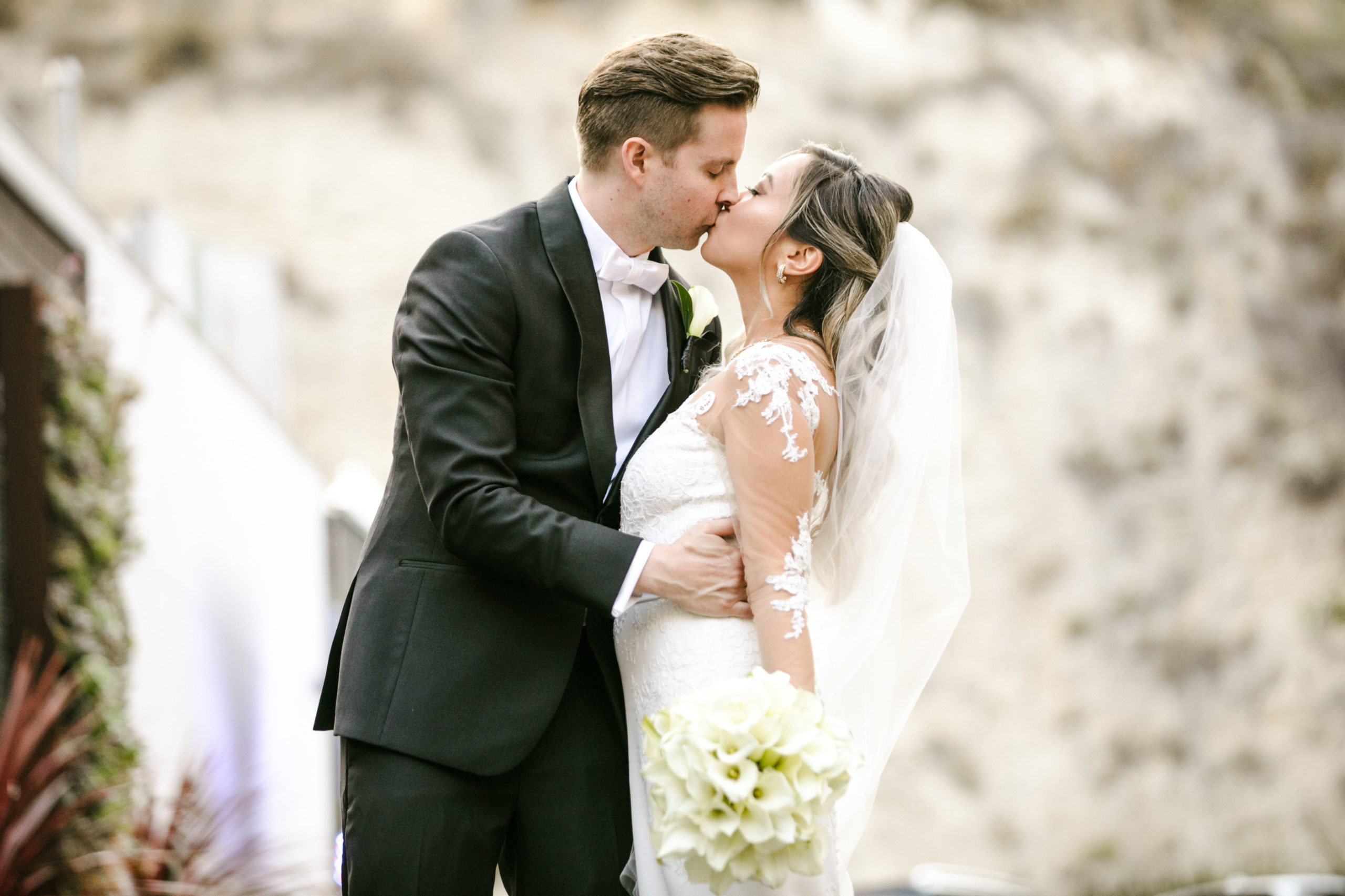 The Top 8 Beach Wedding Venues In Orange County, CA. Newlywed couple sharing a kiss during their wedding shoot in the Ritz-Carlton.