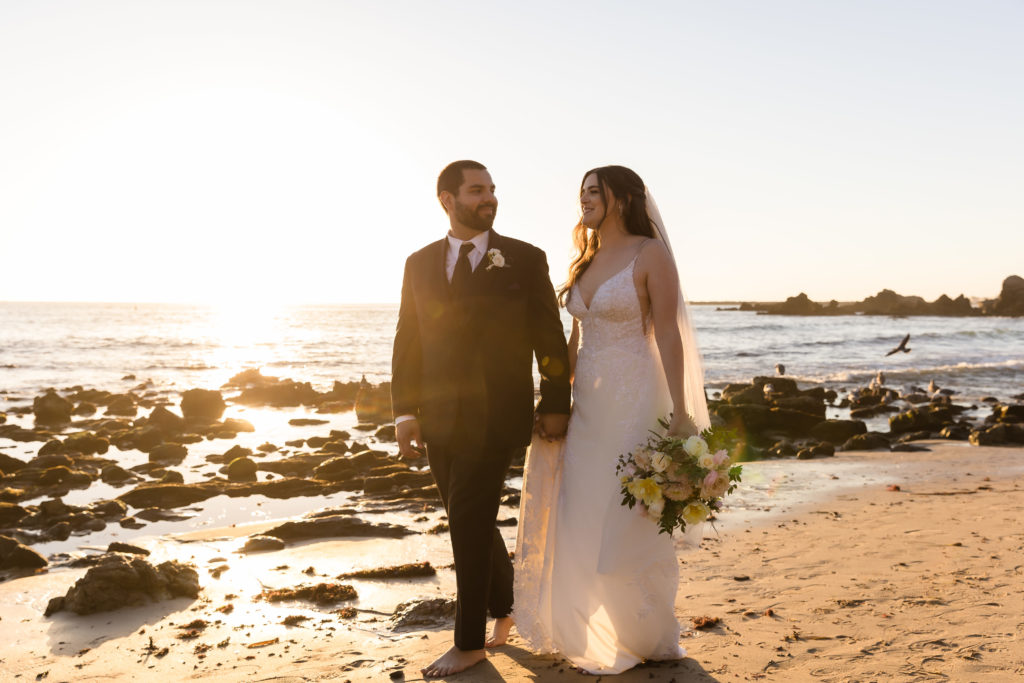 Couple walking together holding hands on the beach at Monarch Beach Resort, one of the Top 8 Beach Wedding Venues In Orange County, CA