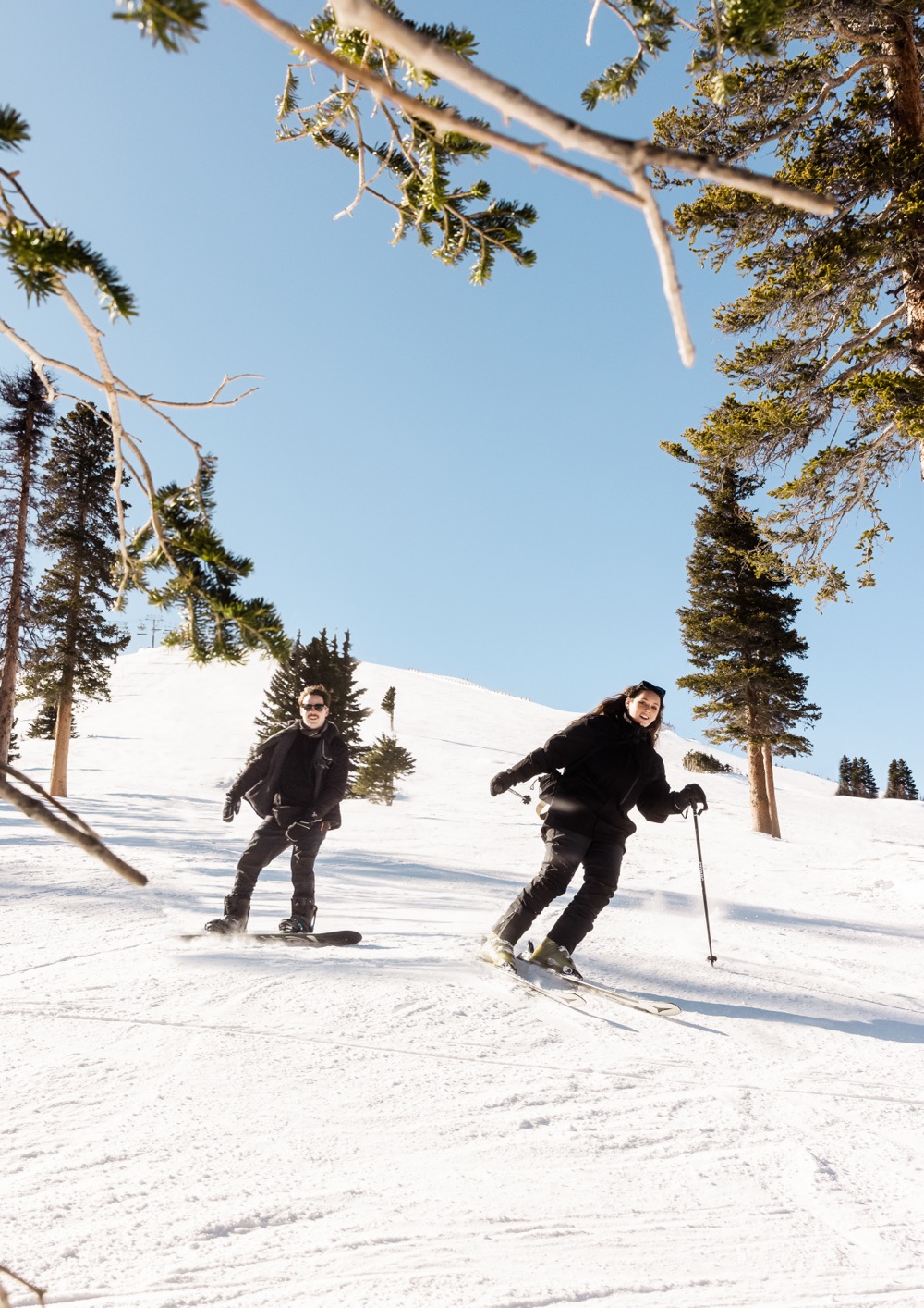 Couple skiing down the mountain during their winter wedding shoot with Christopher Brown Weddings