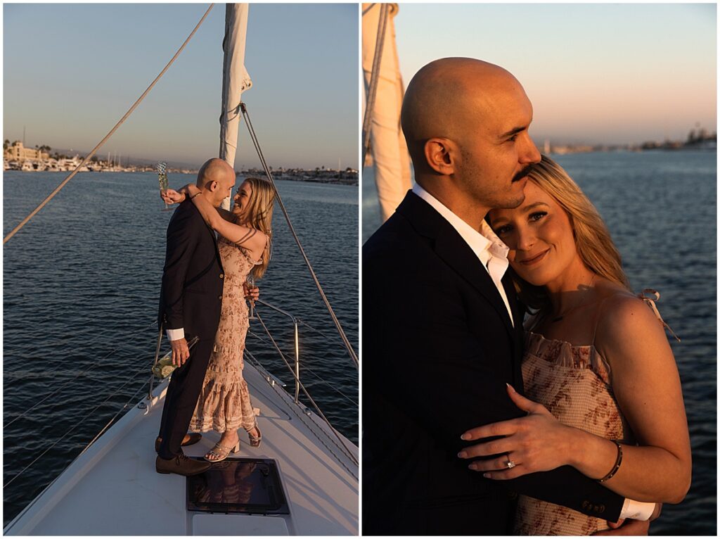 Man in a black suit and woman in a floral dress on a boat holding champagne glasses