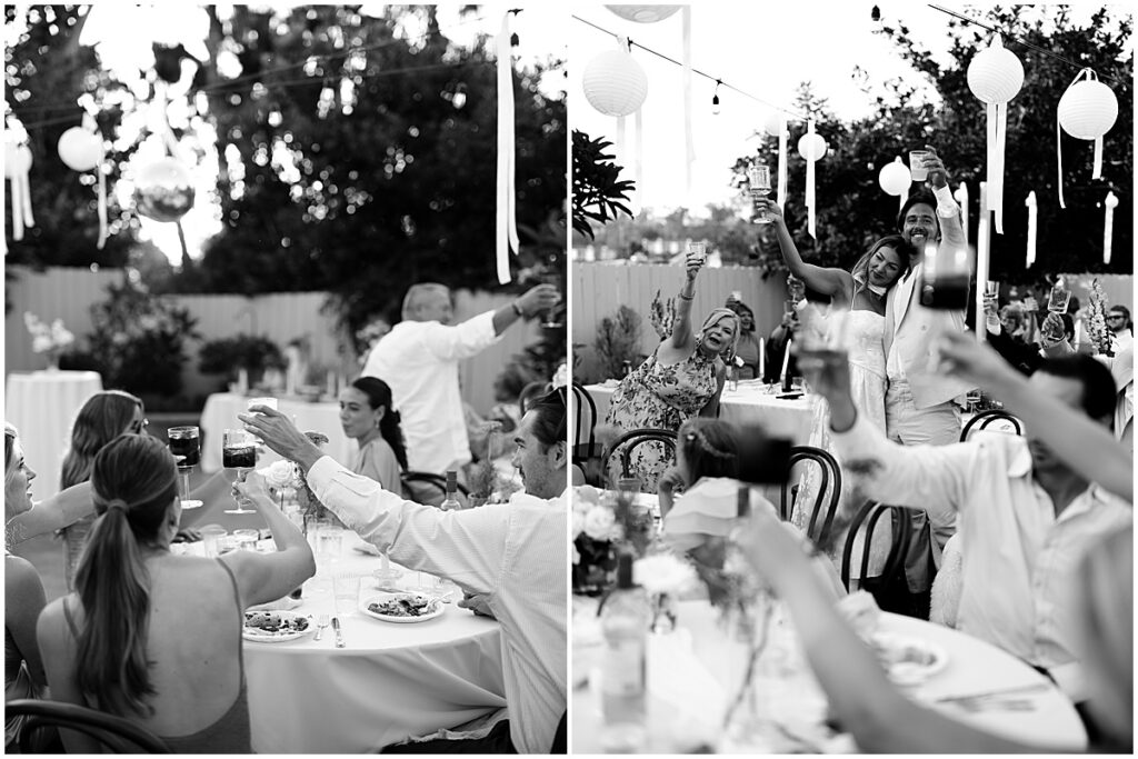 Guests cheersing with drinks held up at San Diego backyard wedding