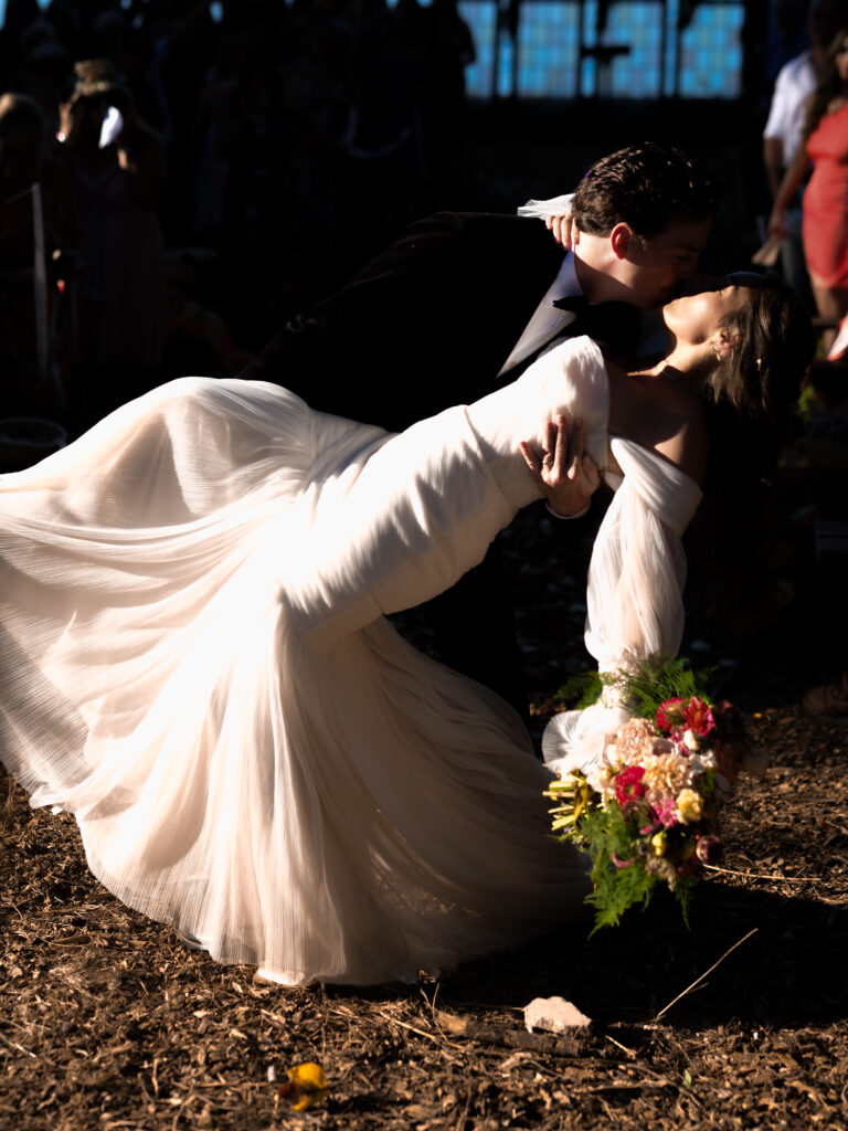 Bride and groom kissing after lakeside wedding ceremony in Idaho