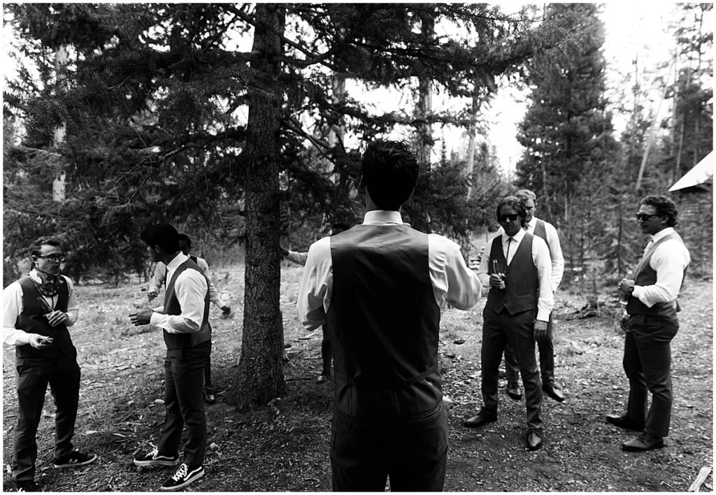 Groom looking at groomsmen for Idaho destination wedding