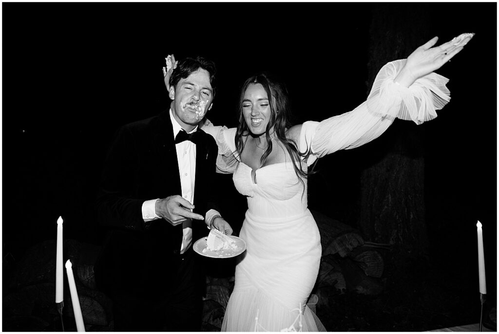 Bride and groom with wedding cake on a plate and cream over grooms face