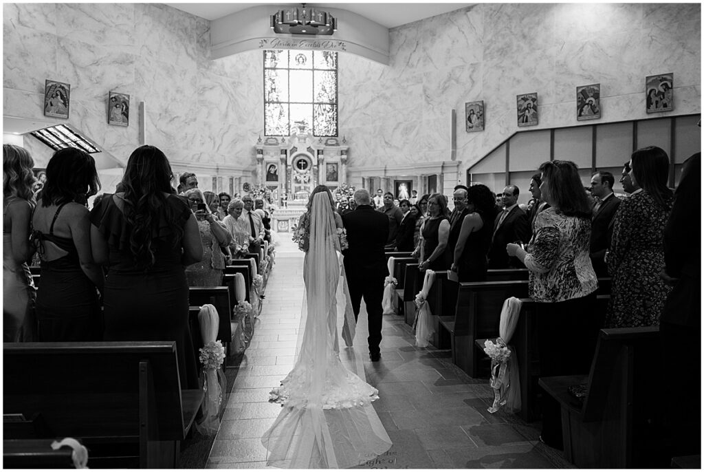 Bride walking down the aisle for wedding at St. Martin De Porres Church in Yorba Linda.