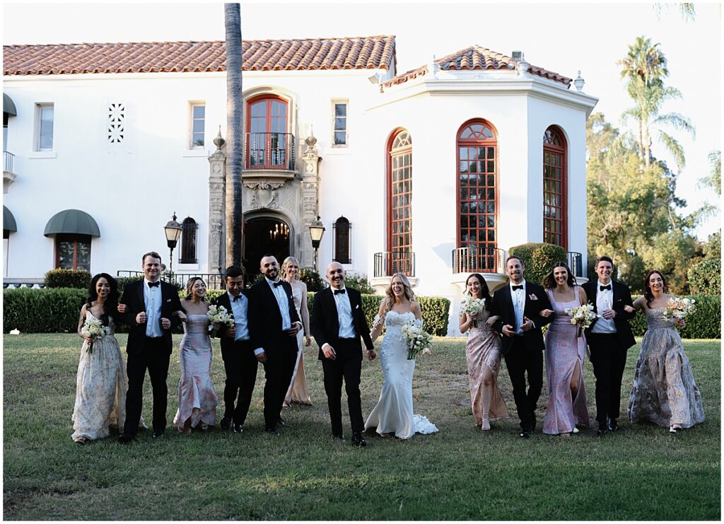 Bridal party wearing pastel dresses and black tuxedos at Muckenthaler Mansion wedding.