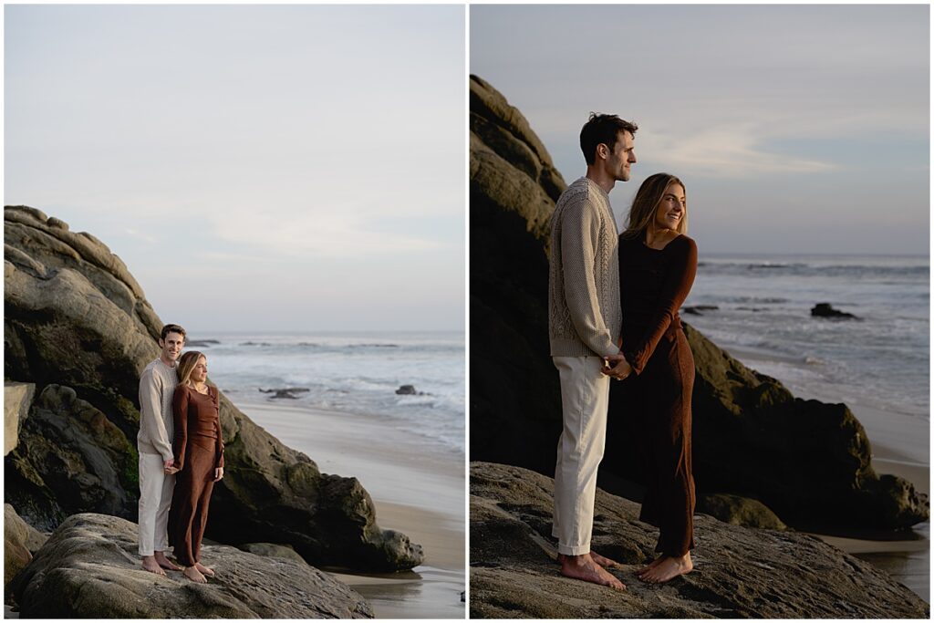 Couple standing on rocks overlooking the ocean at Laguna beach