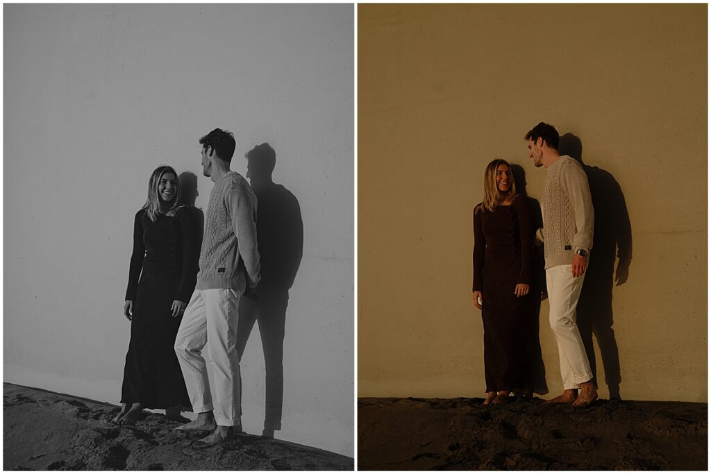 Couple leaning up against white wall at Laguna Beach engagement session