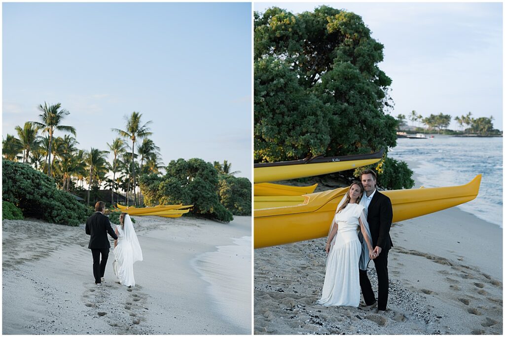 Bride and groom walking along the beach with yellow canoes in the background.