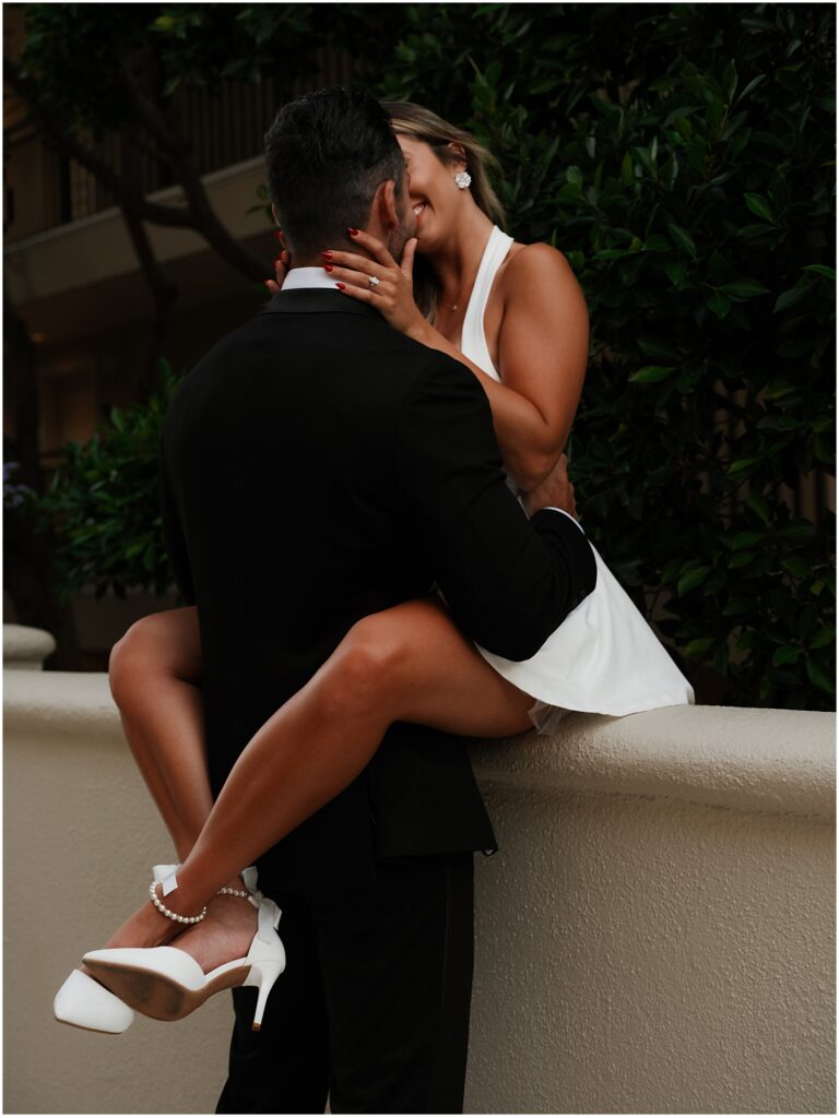 Couple taking engagement photos at Surf and Sand in Laguna Beach